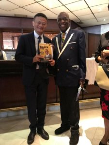 Dr Mensah (right) with Chinese billionaire Jack Ma hold a copy of Dr. Mensah's book